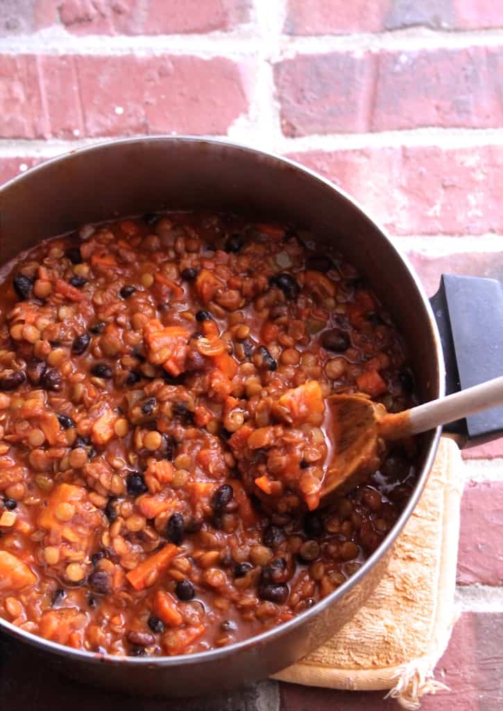 This sweet potato, black bean, and lentil vegetarian chili is healthy and hearty– you'll never miss the meat! Sweet potato chili is healthy comfort food at its finest.
