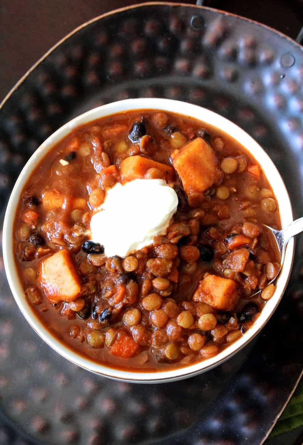This sweet potato, black bean, and lentil chili is healthy and hearty– you'll never miss the meat!