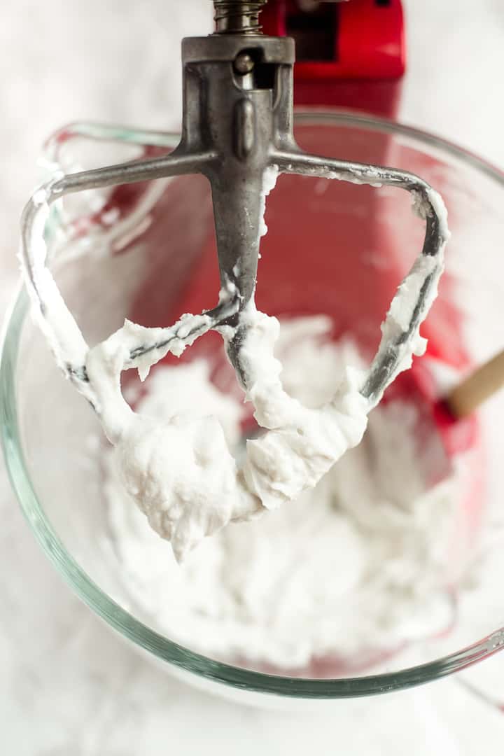 Whipped coconut cream in mixing bowl