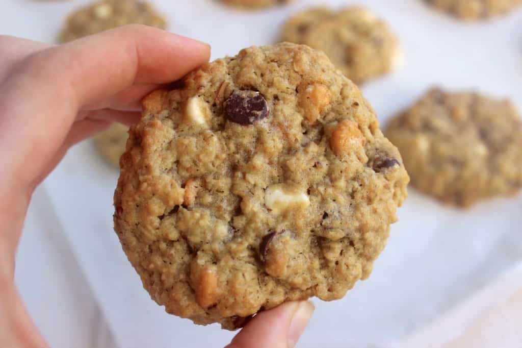 Soft & Chewy Kitchen Sink Cookies with 3 types of chocolate chips, oats, almonds, & walnuts! The possibilities are endless- crushed pretzels, crushed potato chips, chocolate-covered almonds, peanuts, peanut butter chips, and more.