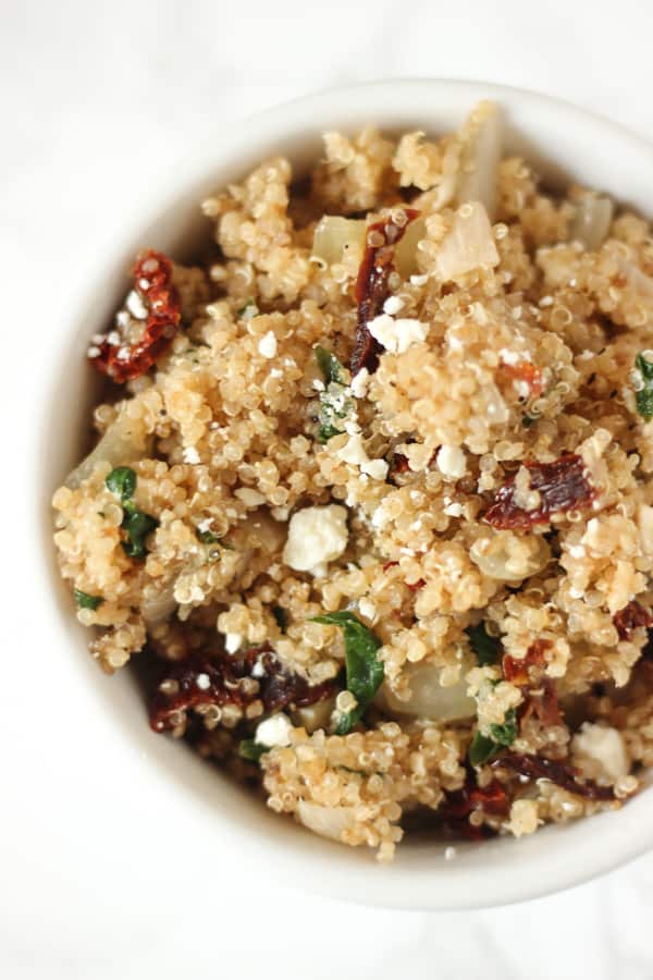 This Mediterranean Quinoa is packed with sun-dried tomatoes & feta! It's a super easy side or main dish 