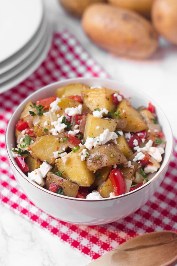 This warm roasted potato salad has a light (mayo-free!) lemon and olive oil dressing, with lots of flavor from fresh roasted red pepper and salty feta cheese