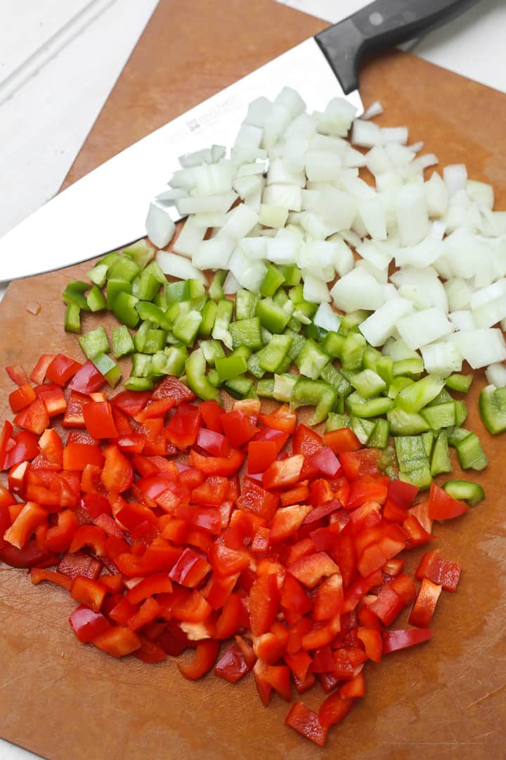 Chopping onions and bell peppers